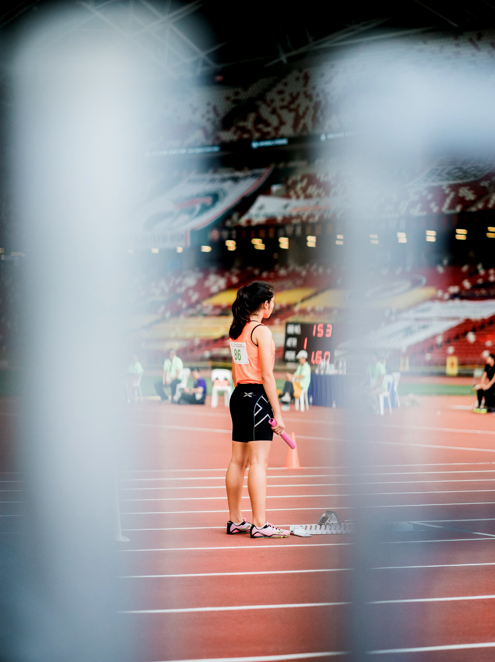 female athlete on a track about to start a race