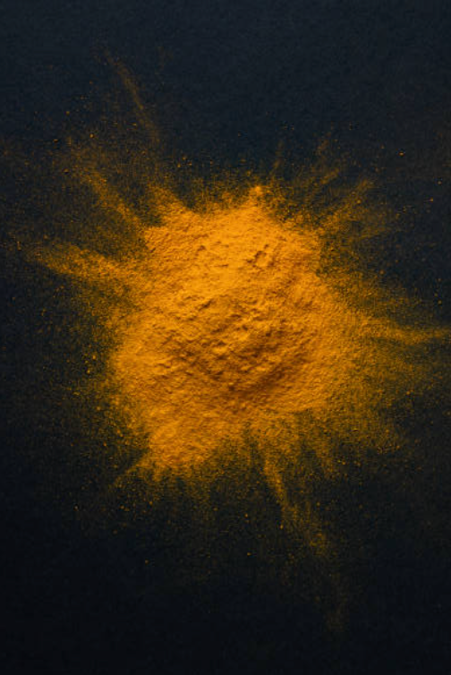 turmeric powder on a black surface